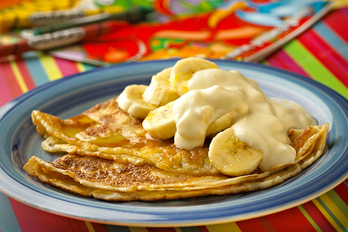 Pancakes served with Banana Slices and Mango Papaya & Passion Fruit